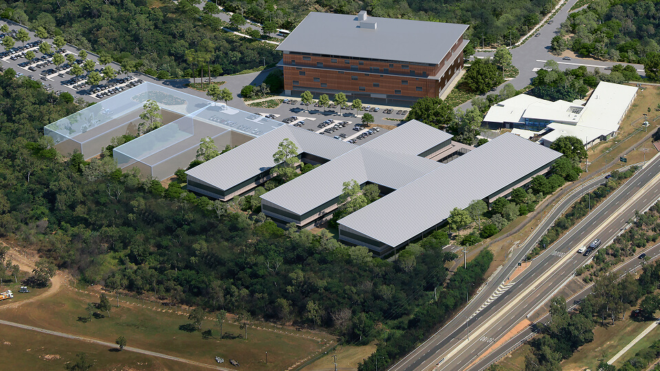 Aerial artist impression of the Townsville University Hospital expansion showing new low-rise clinical buildings integrated into the existing campus and surrounding bushland.