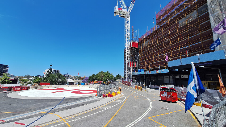 View of the Princess Alexandra Hospital helipad and adjacent construction zone with scaffolding and cranes.