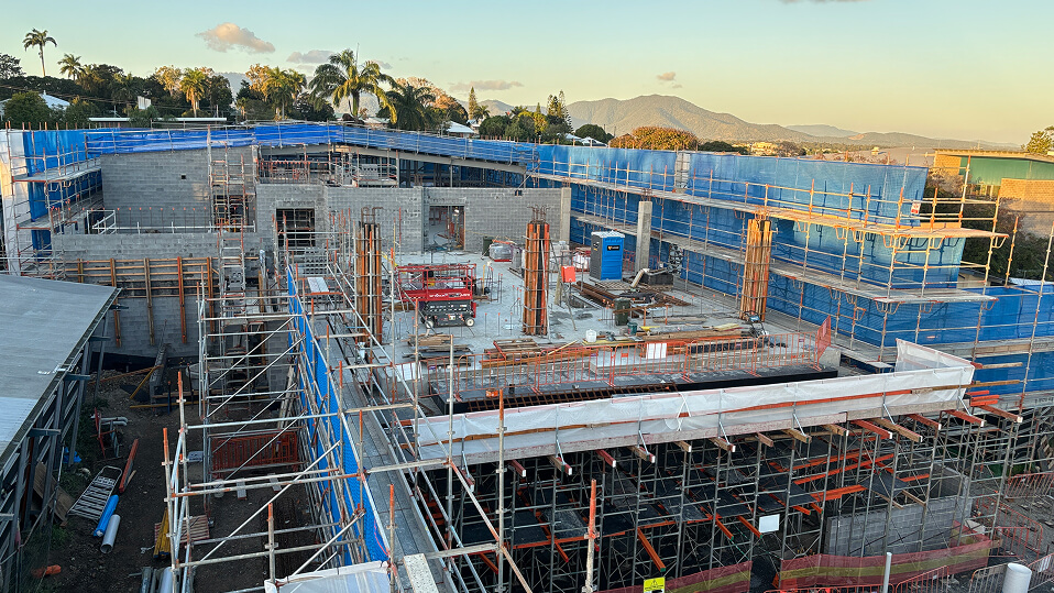 Aerial view of the Rockhampton Mental Health facility construction site with scaffolding and partially built structures.